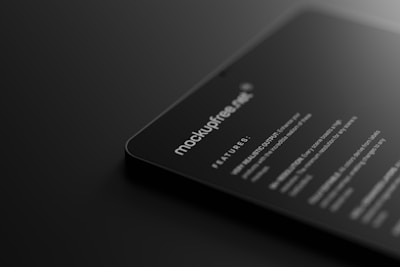 A dark-themed digital mockup showcasing a sleek, rounded-corner device featuring text that includes features and specifications. The text is white against a black background, giving a modern and minimalistic feel.