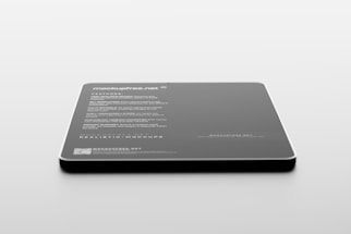 A sleek, rectangular black object with rounded corners rests on a light surface. Text in white is visible on its surface, listing features and specifications, suggesting it is a product mockup or digital screen template.