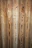 Vertical wooden planks with distinct grain patterns and knots, featuring a natural and rustic appearance.