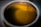 The image features a close-up view of a metallic container filled with a yellow liquid. Two thin metal rods are submerged into the liquid, which seems to be illuminated.