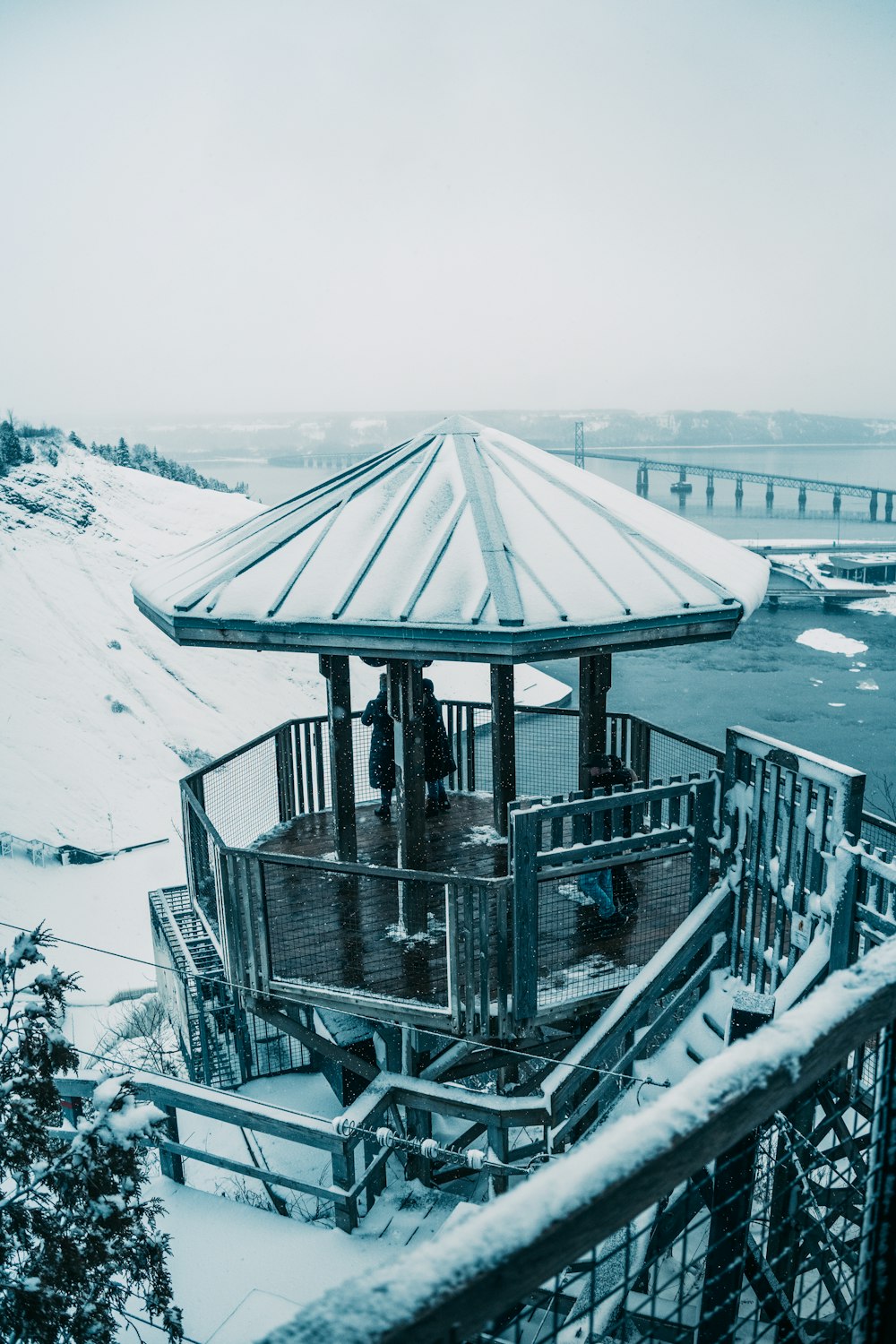 a gazebo in the middle of a snowy field