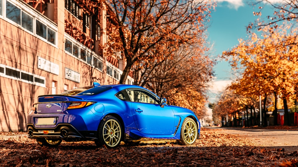 a blue car parked on the side of a road