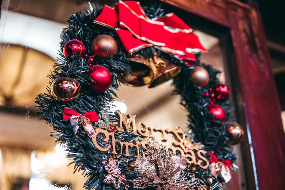 a christmas wreath is hanging on a door