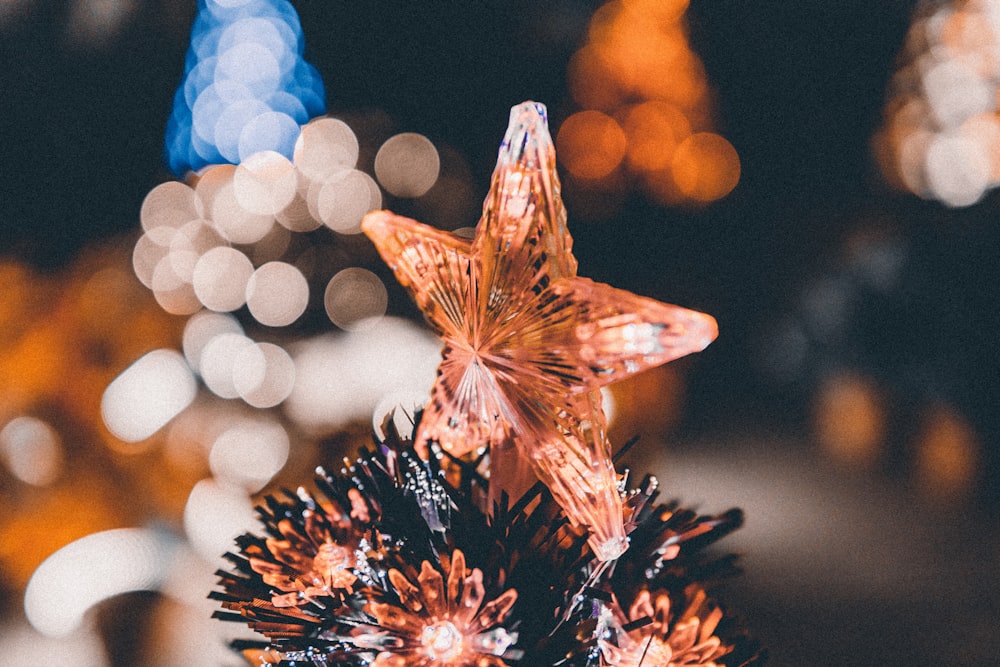 a close up of a christmas tree with lights in the background