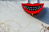 Close-up of a beautifully crafted smile logo sign glowing softly on a wall.