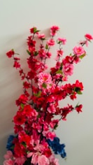 A beautiful arrangement of artificial flowers and decorative grasses.