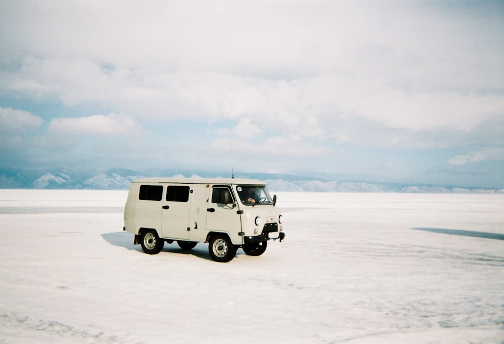 a white vehicle parked in the middle of the desert