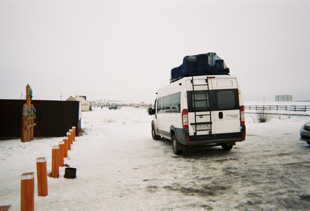 a white van is parked in the snow,