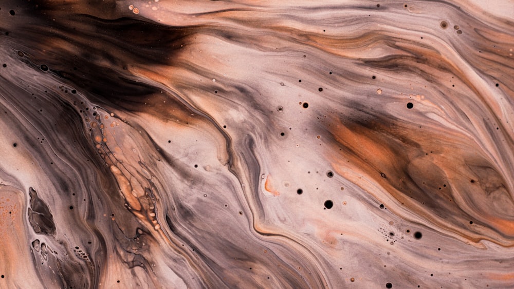 a close up of a brown and black marble