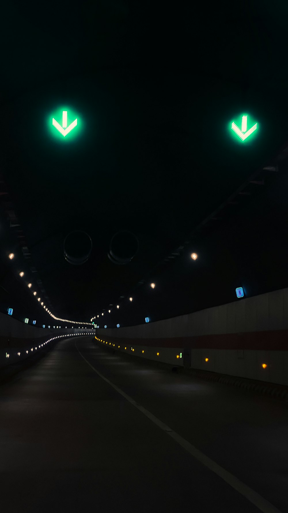 a long tunnel with green lights on both sides