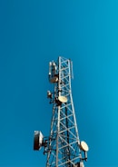 a cell phone tower with a blue sky in the background