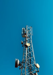 a cell phone tower with a blue sky in the background