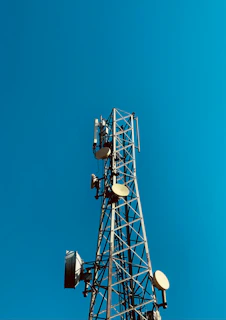 a cell phone tower with a blue sky in the background