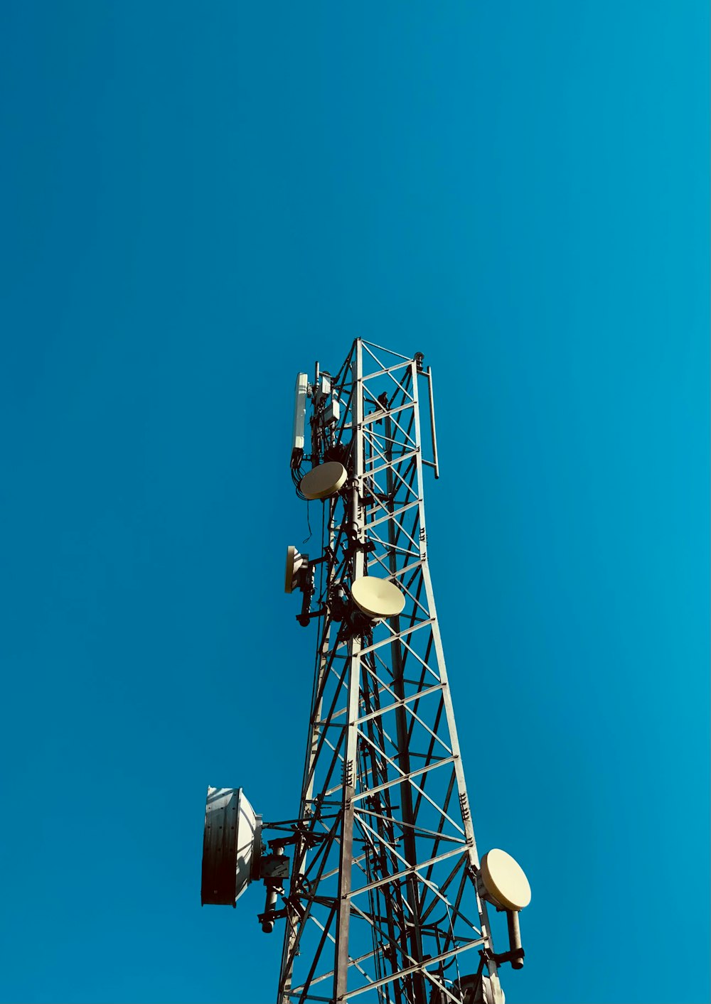 a cell phone tower with a blue sky in the background