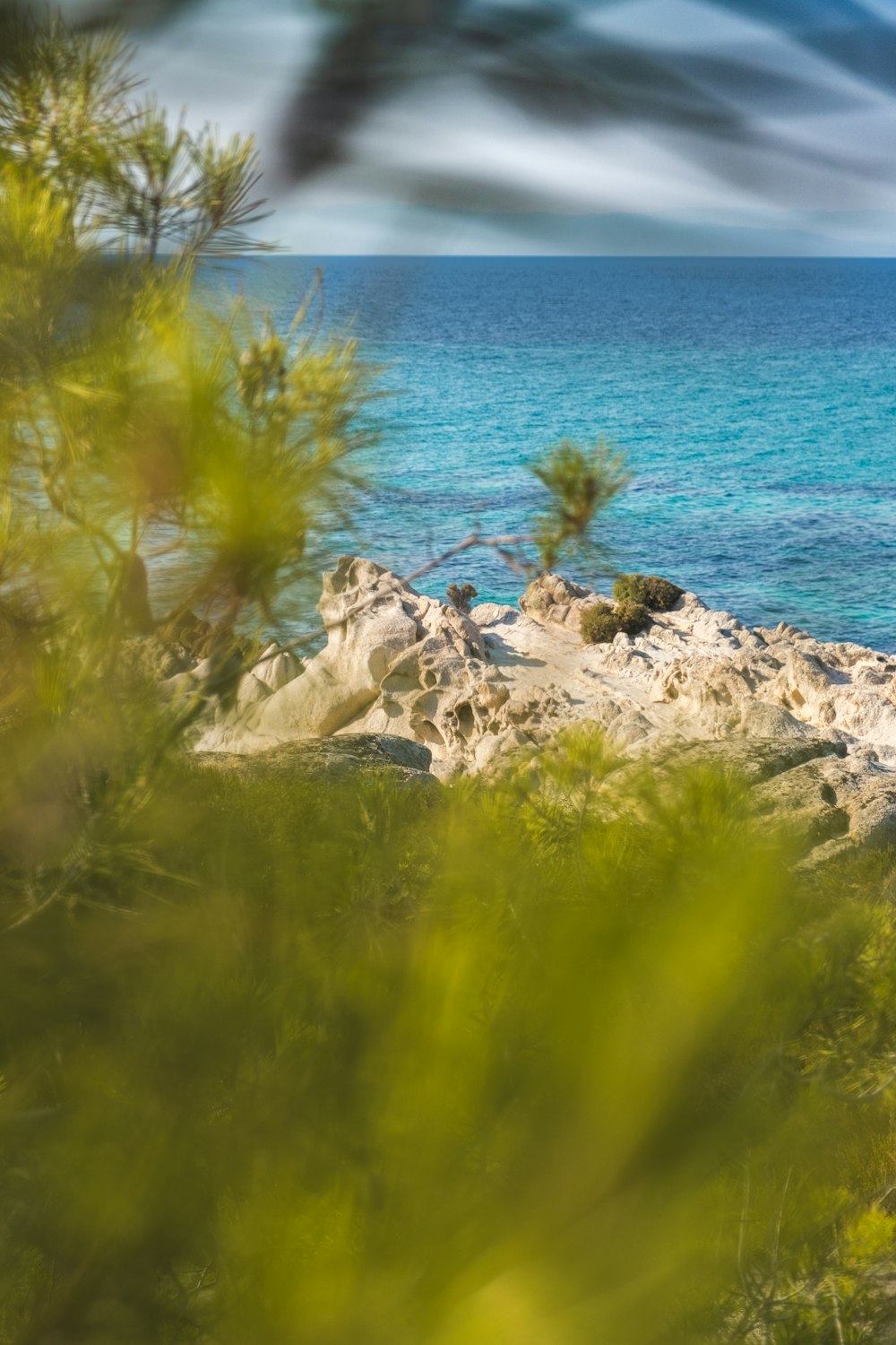 a view of the ocean from a rocky cliff