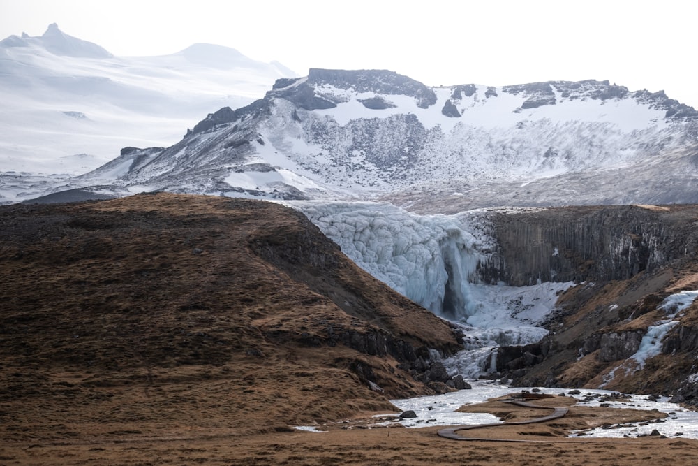 a view of a mountain with a frozen waterfall