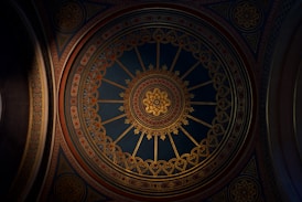 a ceiling in a building with a clock on it