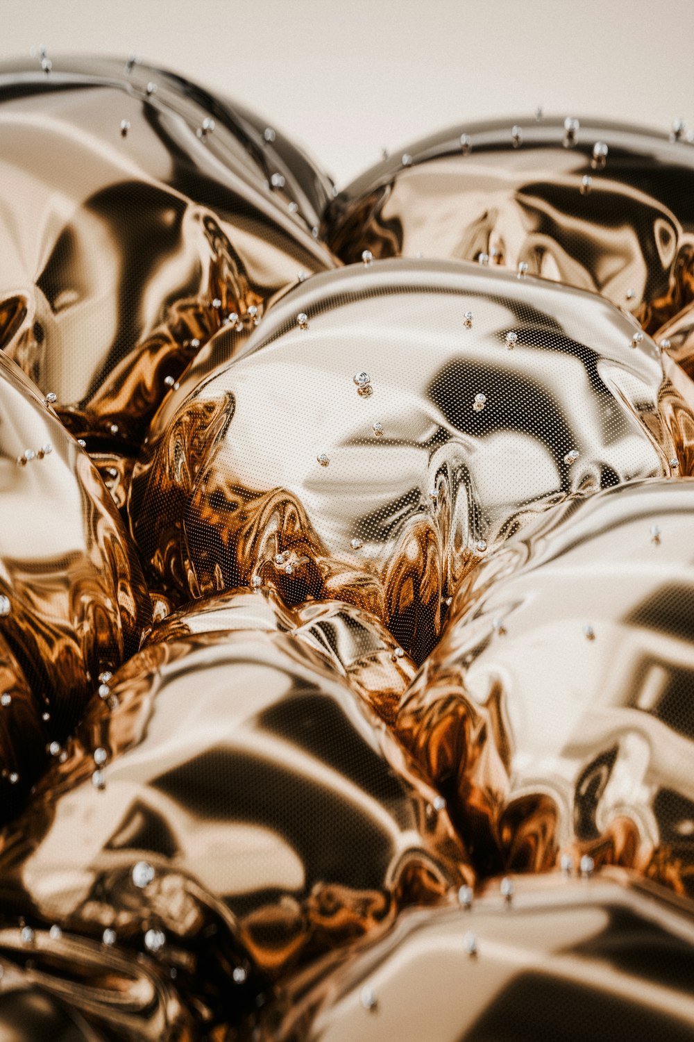 a pile of shiny metal objects sitting on top of a table