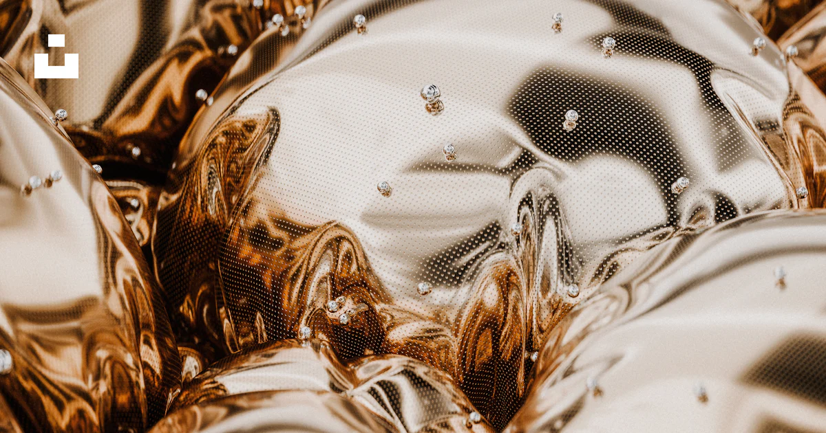 A pile of shiny metal objects sitting on top of a table photo – Free ...