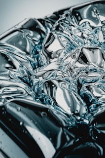 Abstract close-up of electrical currents dancing over a metallic surface under soft light.