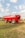 a big red truck is parked in a field