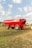 a big red truck is parked in a field