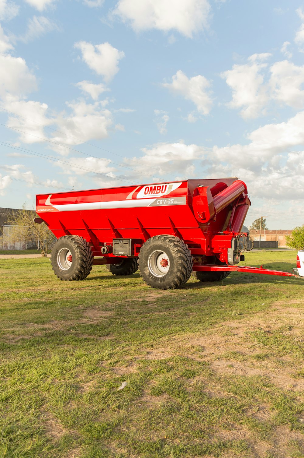 a big red truck is parked in a field