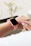 Close-up of a blush pink Poshevo nurse watch on a nurse’s wrist during a hospital shift.