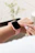Close-up of a blush pink Poshevo nurse watch on a nurse’s wrist during a hospital shift.