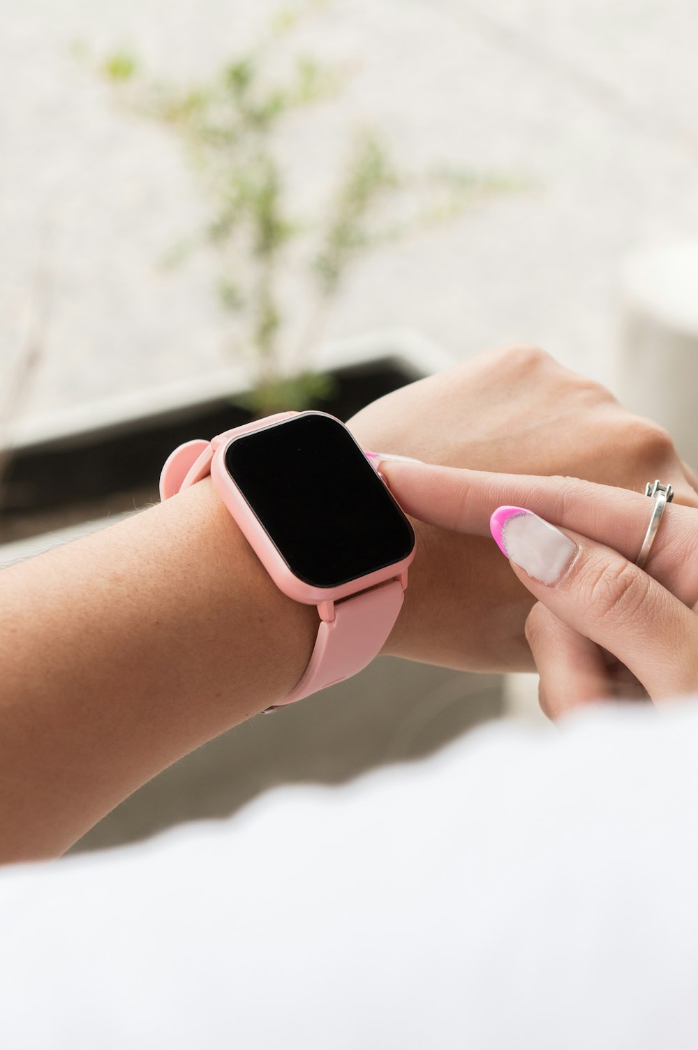 a woman with a pink apple watch on her wrist