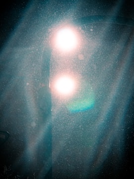 Light beams piercing through a misty silver gradient, evoking supreme intelligence.