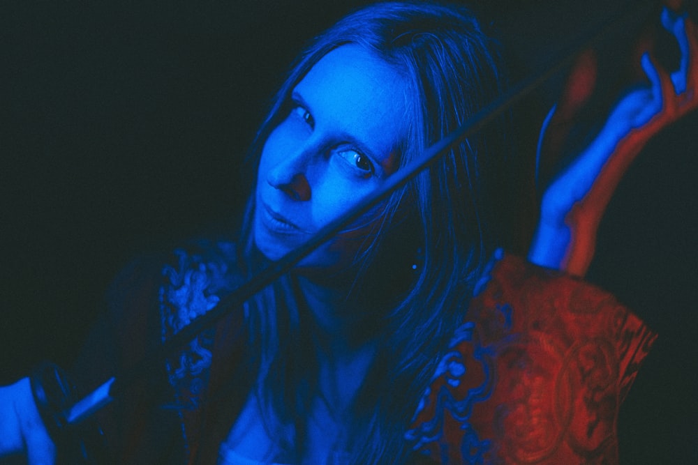 a woman with long hair holding a knife