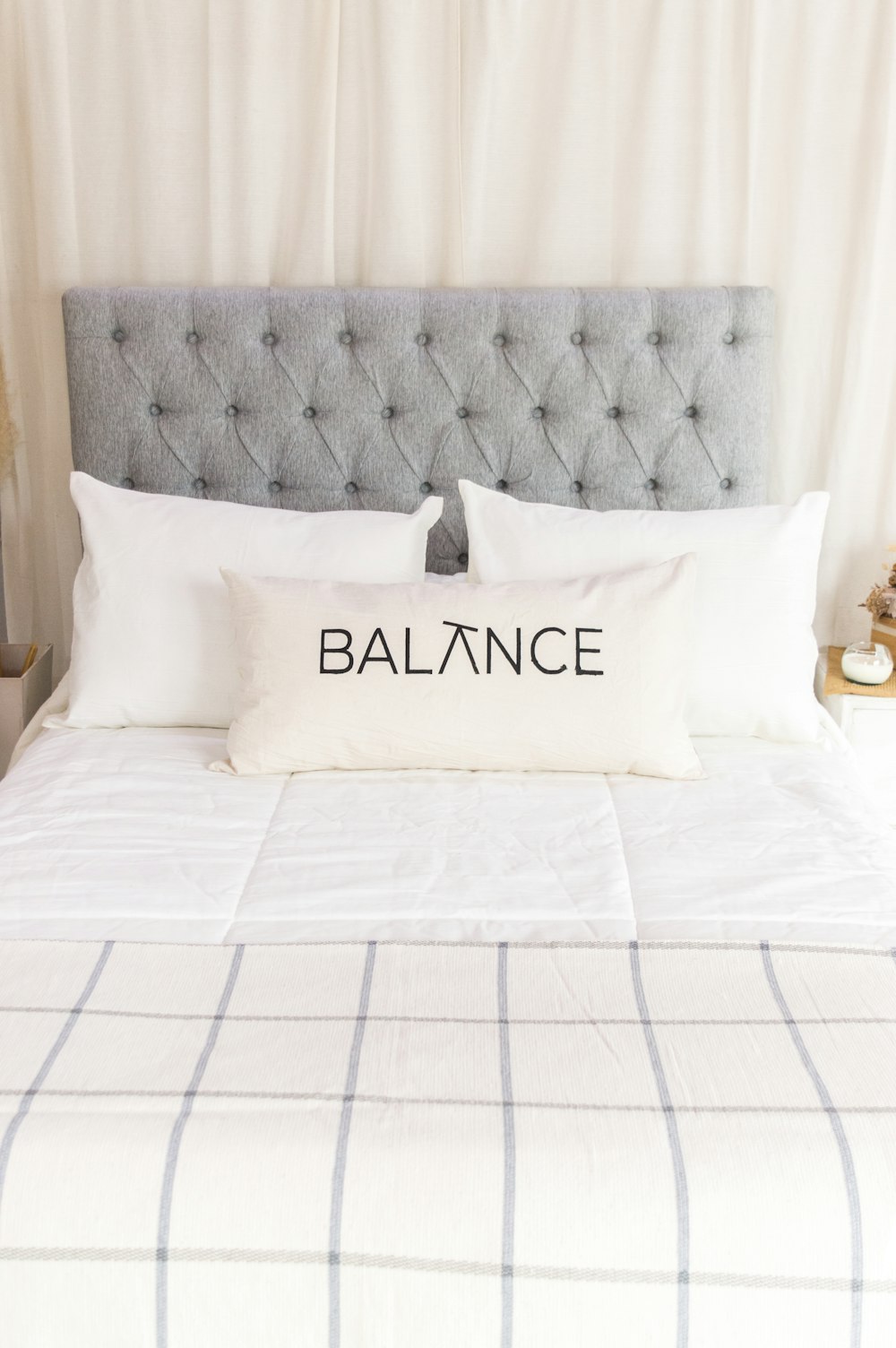 a bed with a pillow that says balance on it