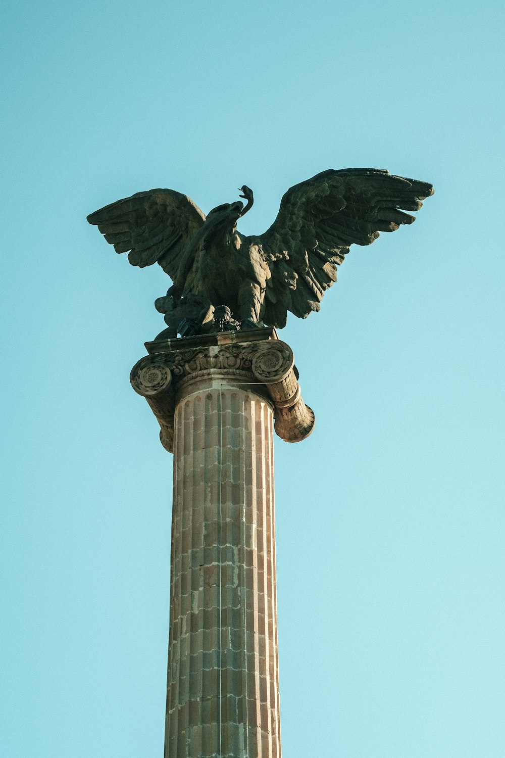 a statue of an eagle on top of a pillar