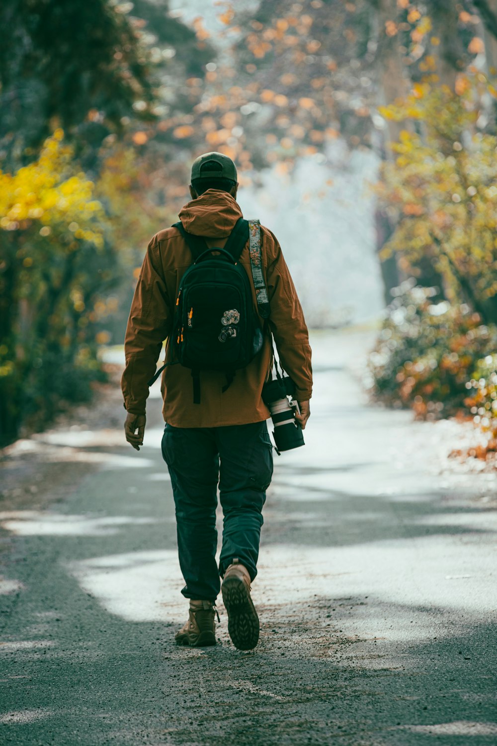 a man with a backpack walking down a road