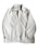 A light beige or off-white jacket with a zipper closure and a collar. The jacket has long sleeves with elastic cuffs and side pockets. The fabric appears to be smooth and slightly shiny. A label is visible on the inside near the collar.