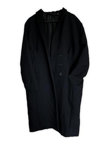 A long black coat featuring a minimalist design with a single-breasted button closure. The coat has two large front pockets and appears to be made of a heavy fabric suitable for colder weather.