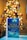 A book titled 'The Christmas Wish' by Nora Roberts is prominently displayed in the foreground, resting on a flat surface. The background features a warmly lit Christmas tree adorned with lights and ornaments, creating a cozy and festive atmosphere.
