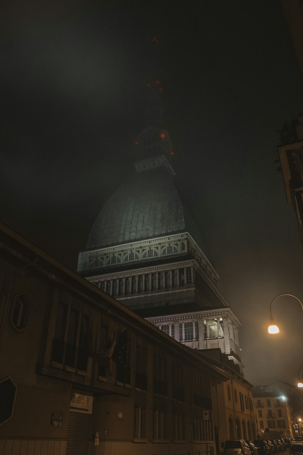 a very tall building with a clock tower at night