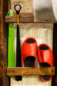 A sleek wooden shoe rack neatly holding various pairs of shoes in a bright entryway.