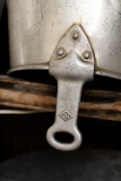 Detail of a polished wooden handle with visible grain and metal rivets