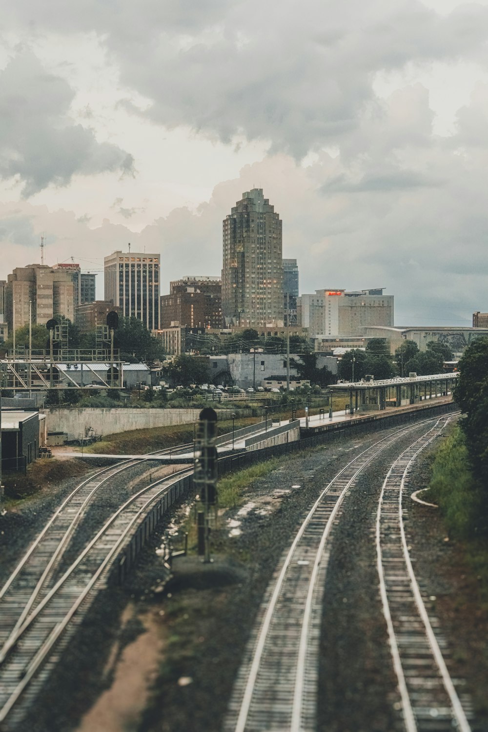 a view of a train track with a city in the background