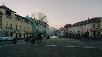 A quiet street in a Ukrainian town, with children walking together under a cloudy sky.