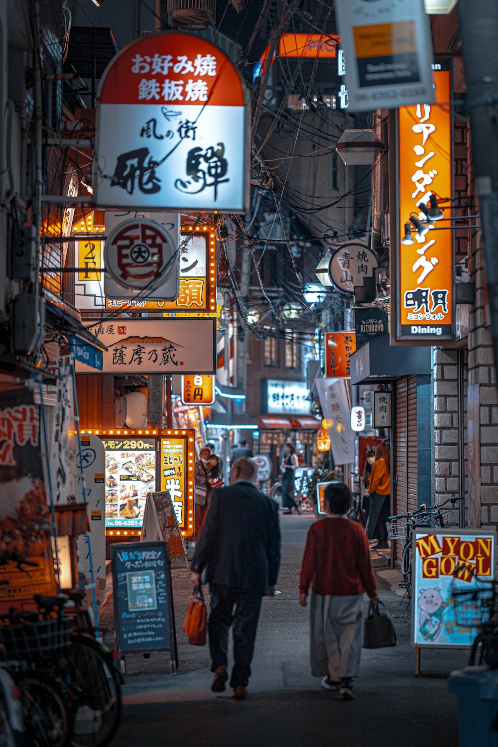 a couple of people that are walking down a street