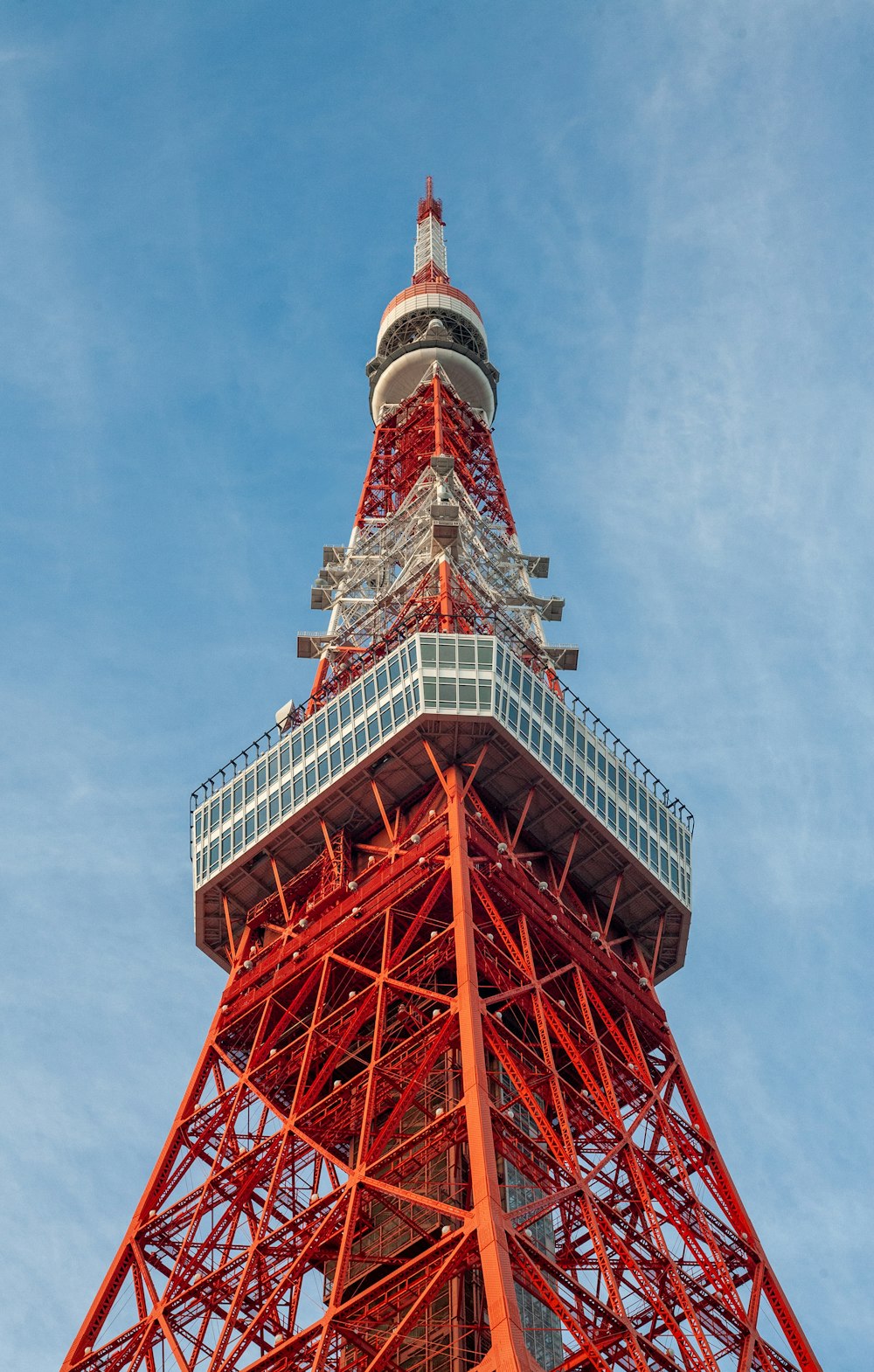 a very tall red tower with a sky background