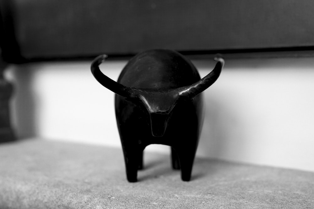 a black bull statue sitting on top of a counter