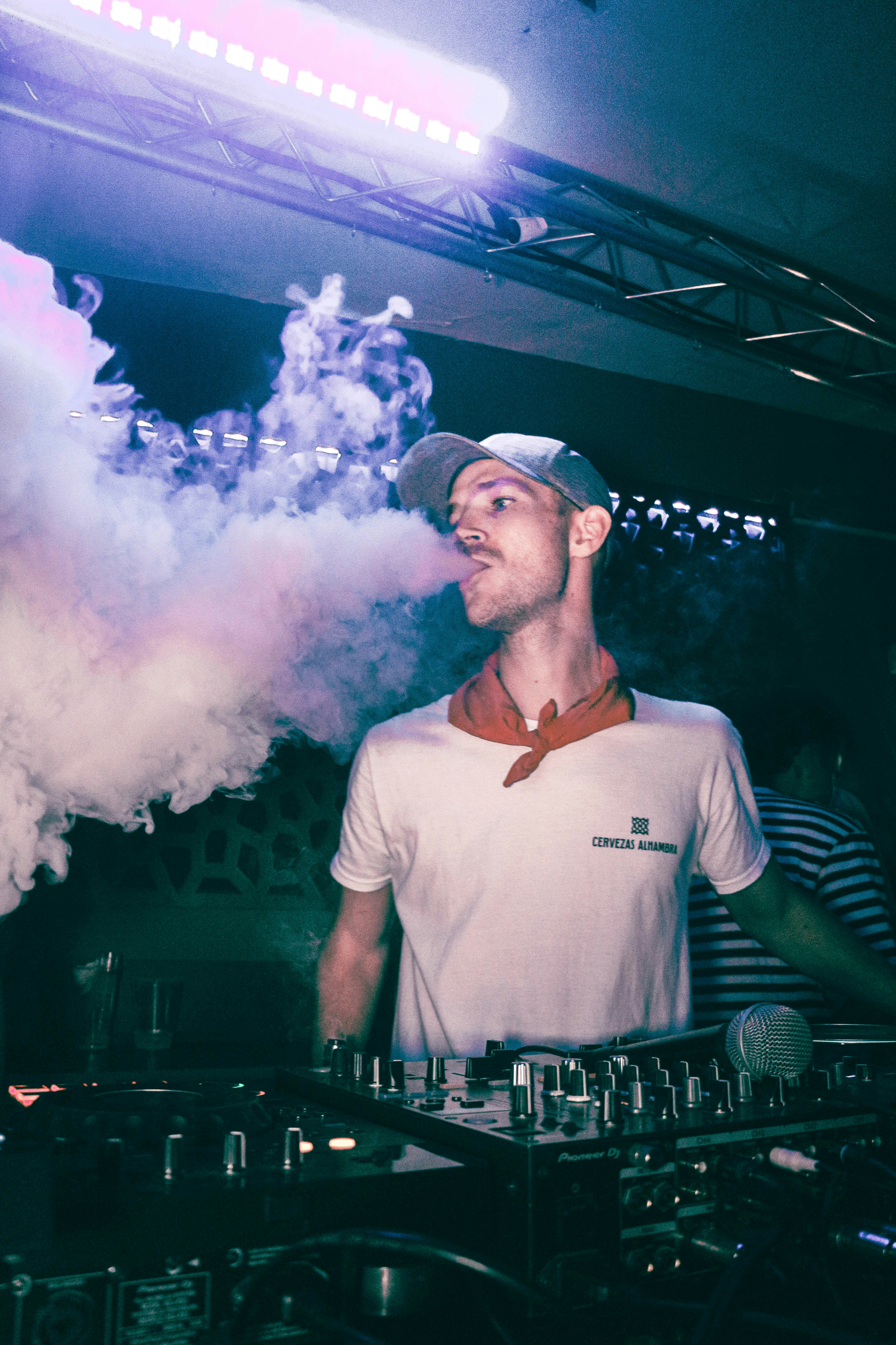 a man standing in front of a smoke machine