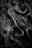 A dark, detailed sculpture features several intertwined human figures, frozen in various expressions of anguish and struggle. The textures and shadows emphasize the emotional intensity of the scene.