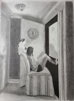 An intimate moment of an artist sketching while a cat naps beside them.