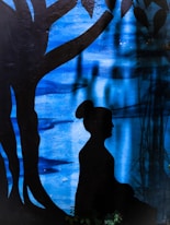 A peaceful outdoor scene with someone meditating under a large tree, symbolizing calm and mindfulness.